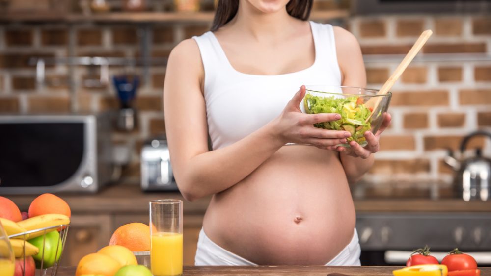 Healthy Pregnant Woman Eating Nutritious Food Or Exercising Under Guidance - NRKSS Blog